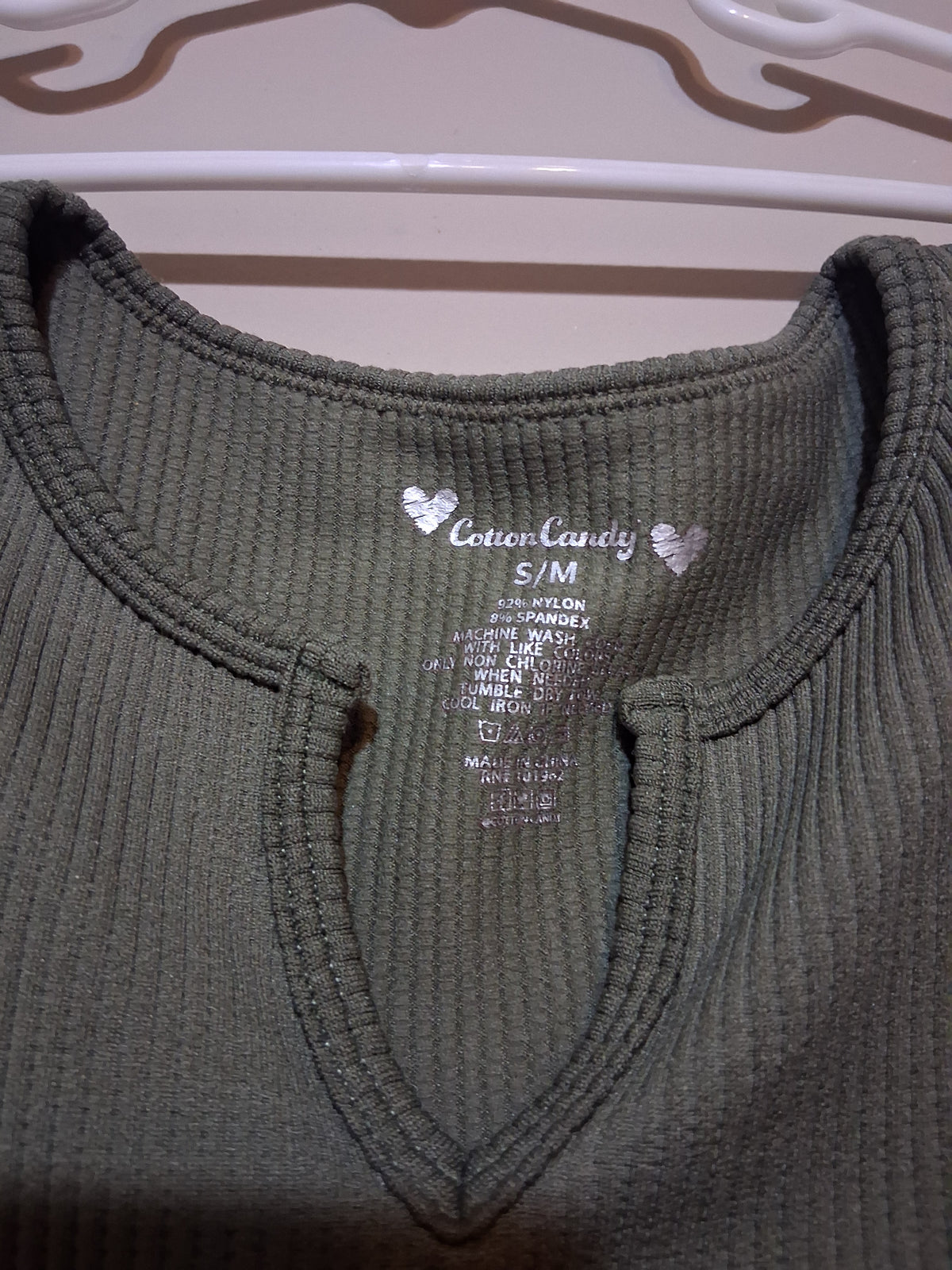 Olive Green Ribbed Keyhole Top showing a keyhole neckline and fabric tag.