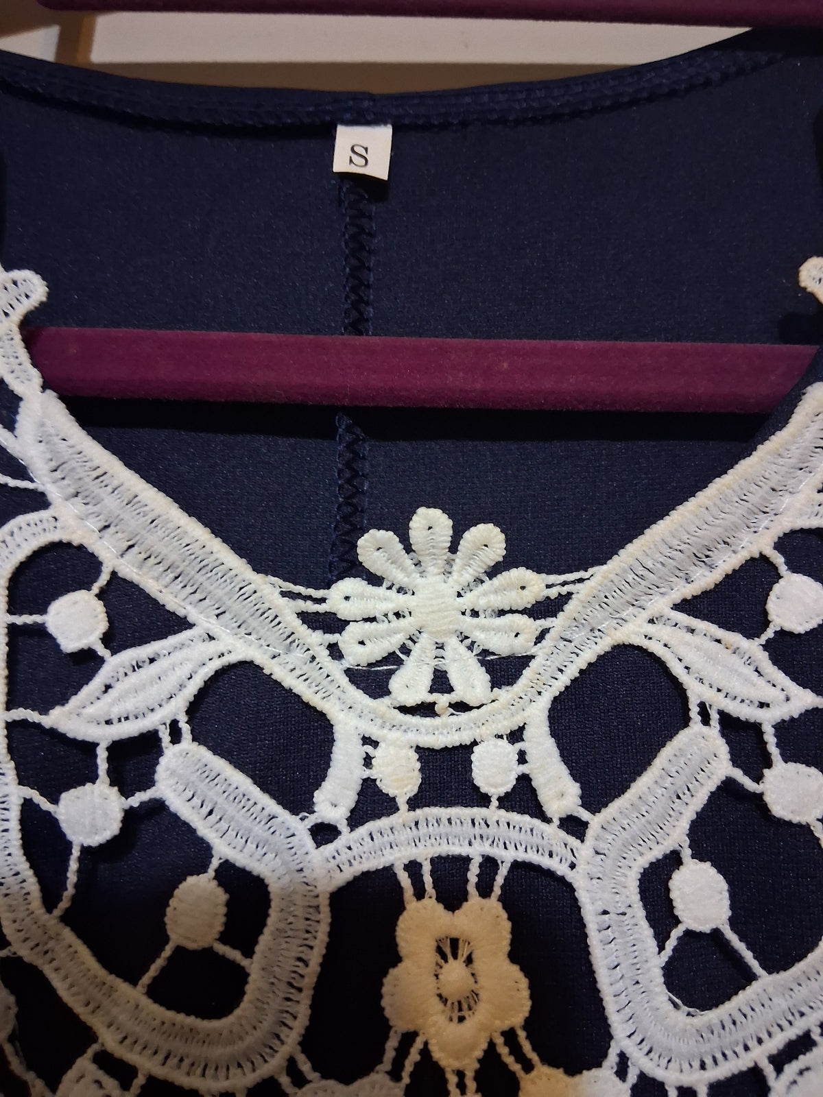 Navy & White Lace Accent Dress showing intricate white lace detailing on the neckline.
