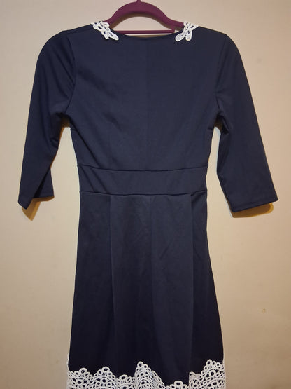Navy & White Lace Accent Dress featuring 3/4 sleeves and delicate white lace hem detail.