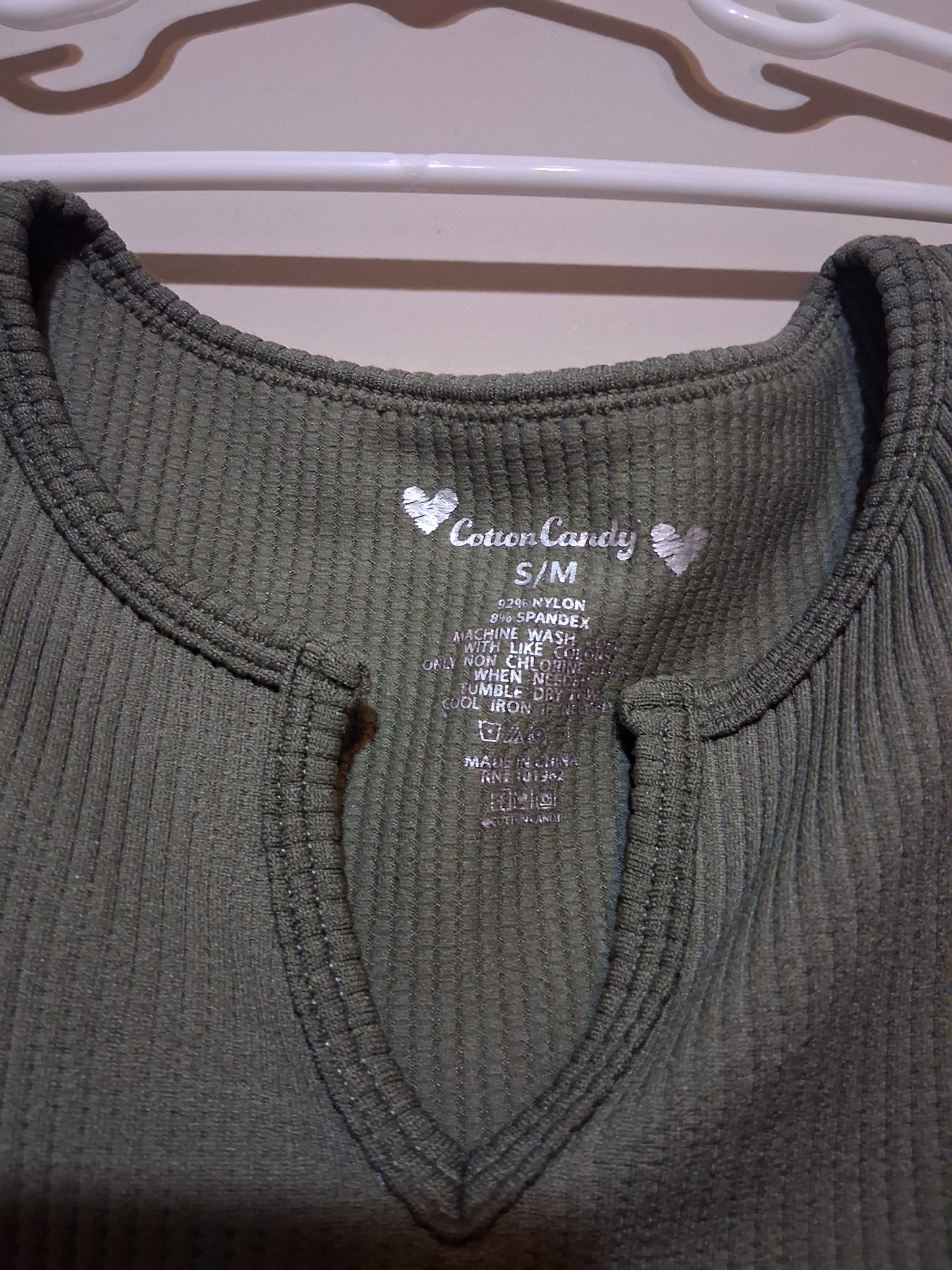 Olive Green Ribbed Keyhole Top showing a keyhole neckline and fabric tag.