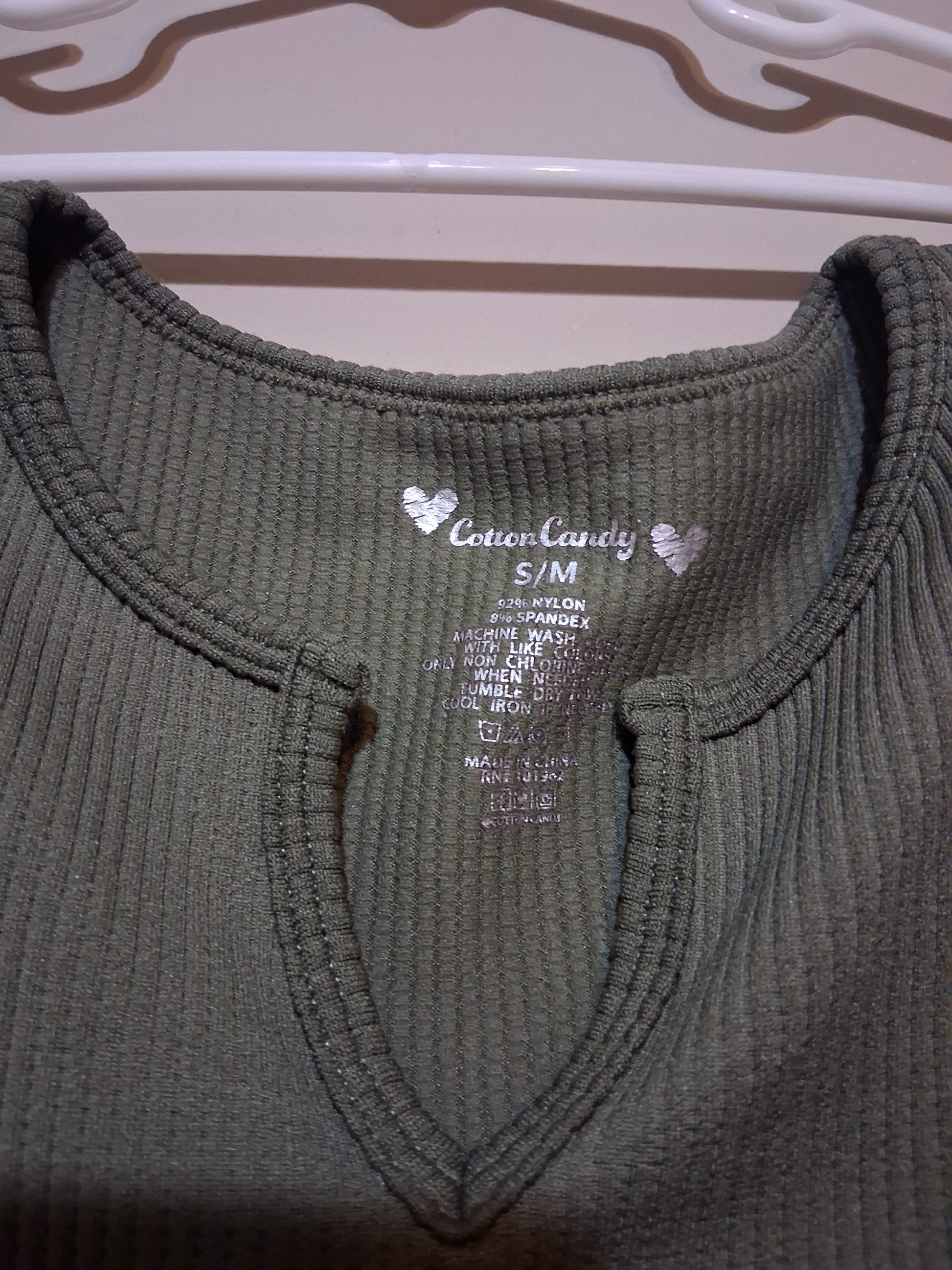 Olive Green Ribbed Keyhole Top showing a keyhole neckline and fabric tag.