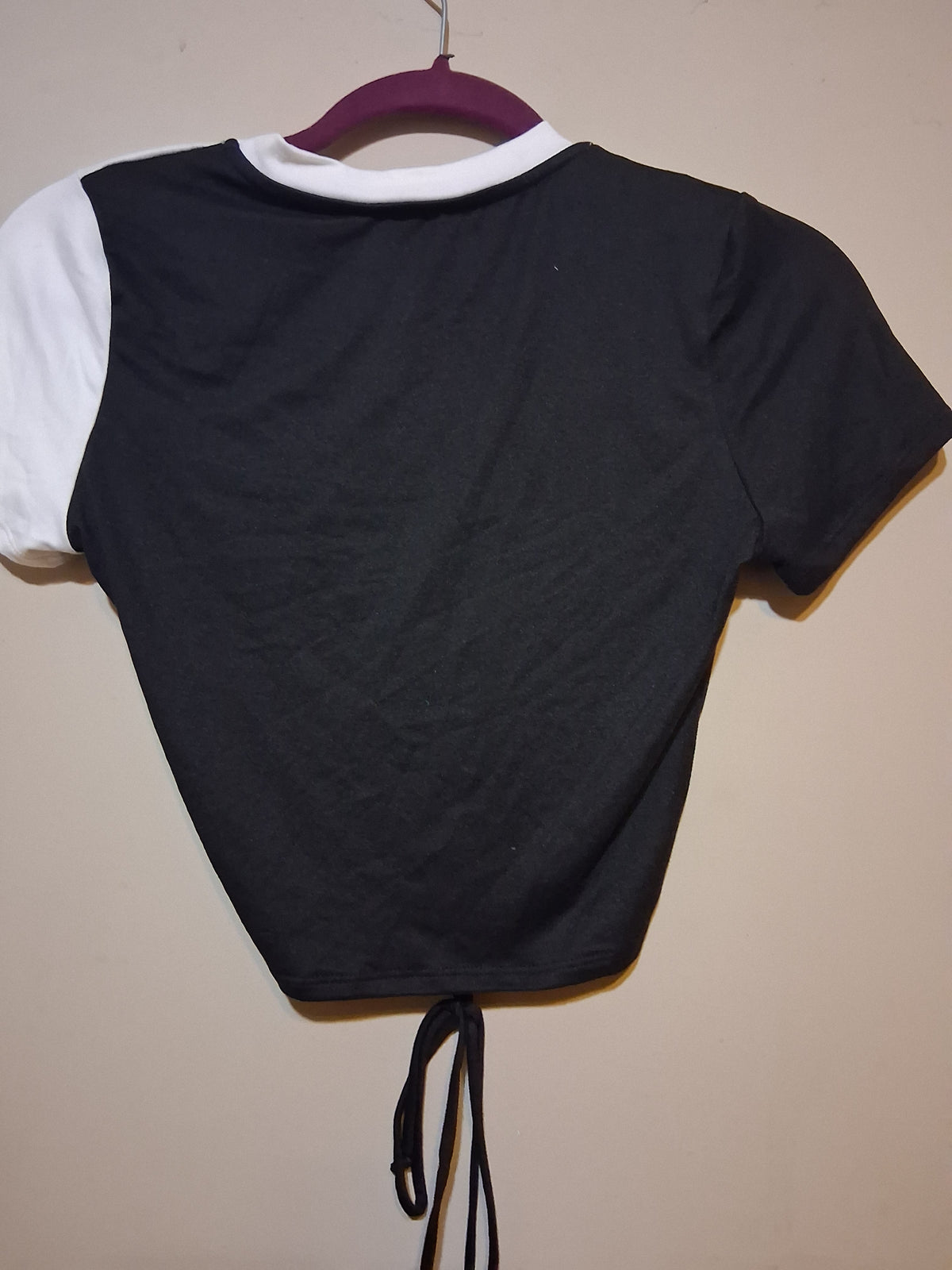 Back view of Black & White Color Block Drawstring Crop Top showcasing the asymmetrical design and adjustable tie.