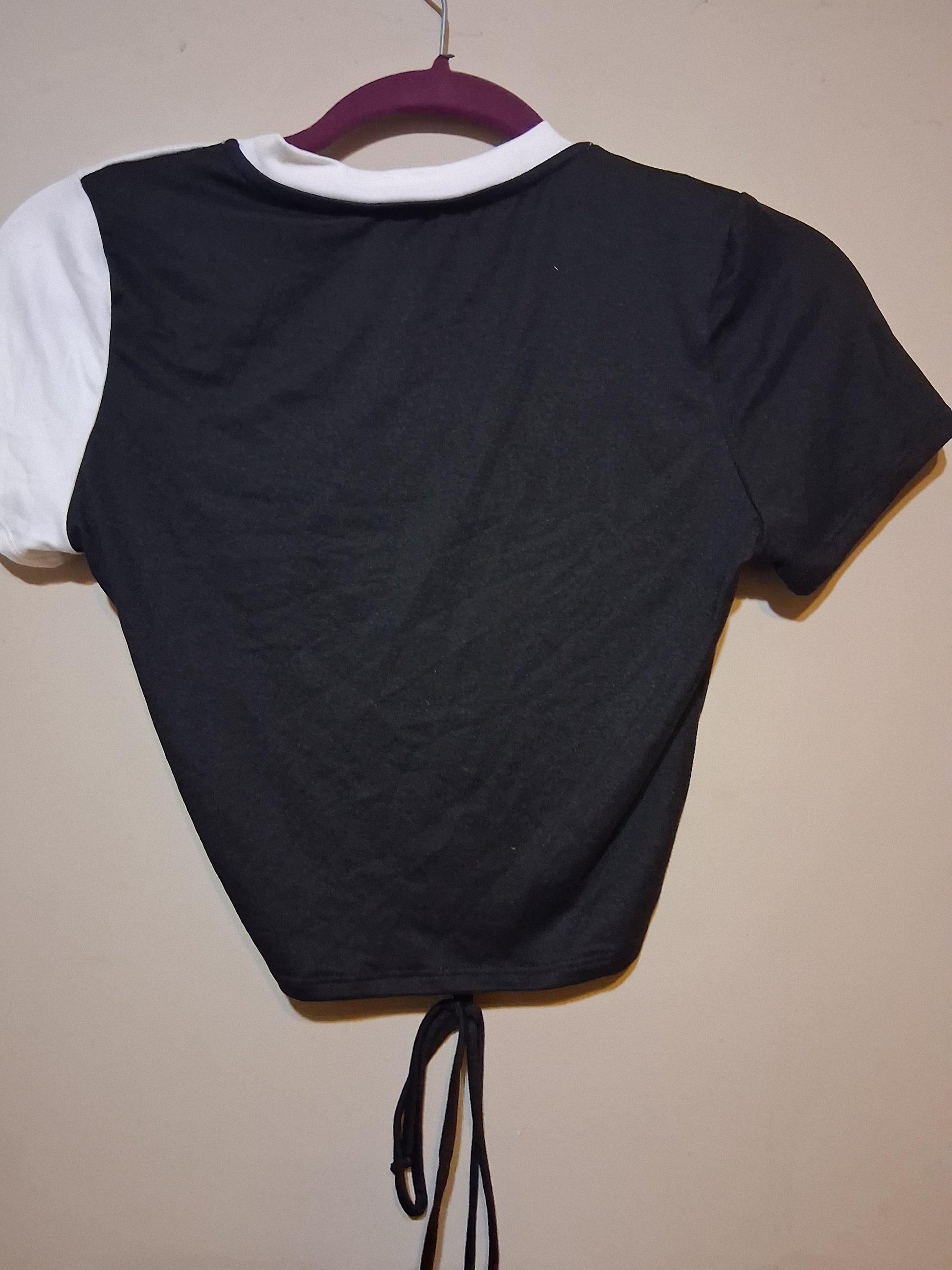 Back view of Black & White Color Block Drawstring Crop Top showcasing the asymmetrical design and adjustable tie.