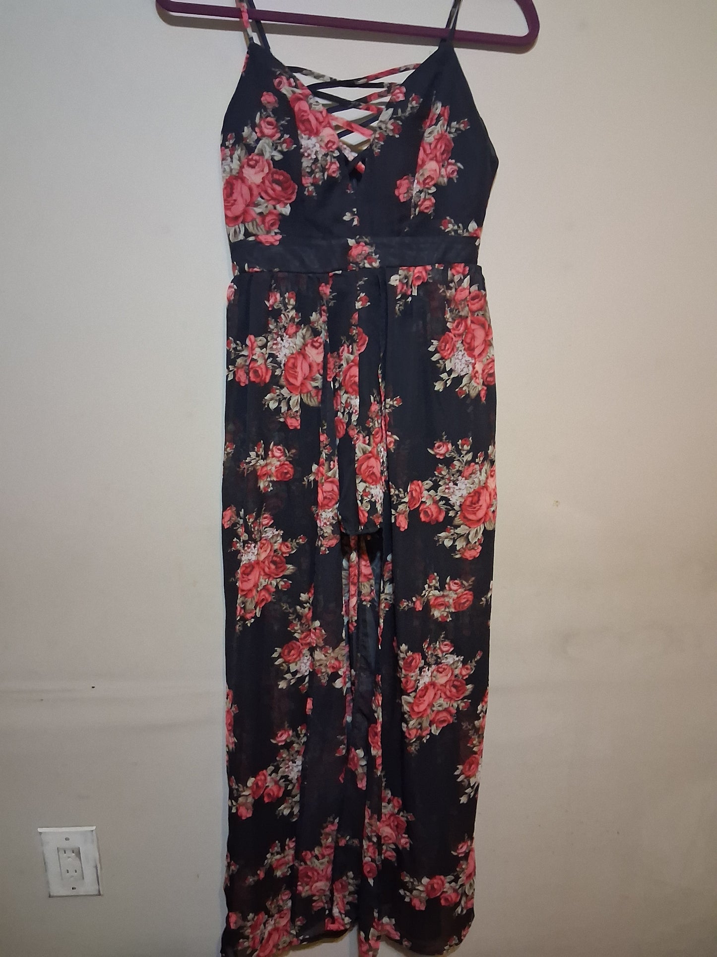 Floral Lace-Up Wide Leg Jumpsuit with black backdrop and pink roses, featuring lace-up detail and spaghetti straps.