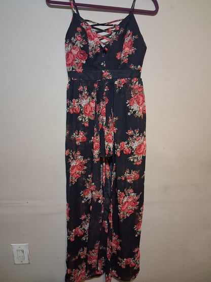 Floral Lace-Up Wide Leg Jumpsuit with black backdrop and pink roses, featuring lace-up detail and spaghetti straps.