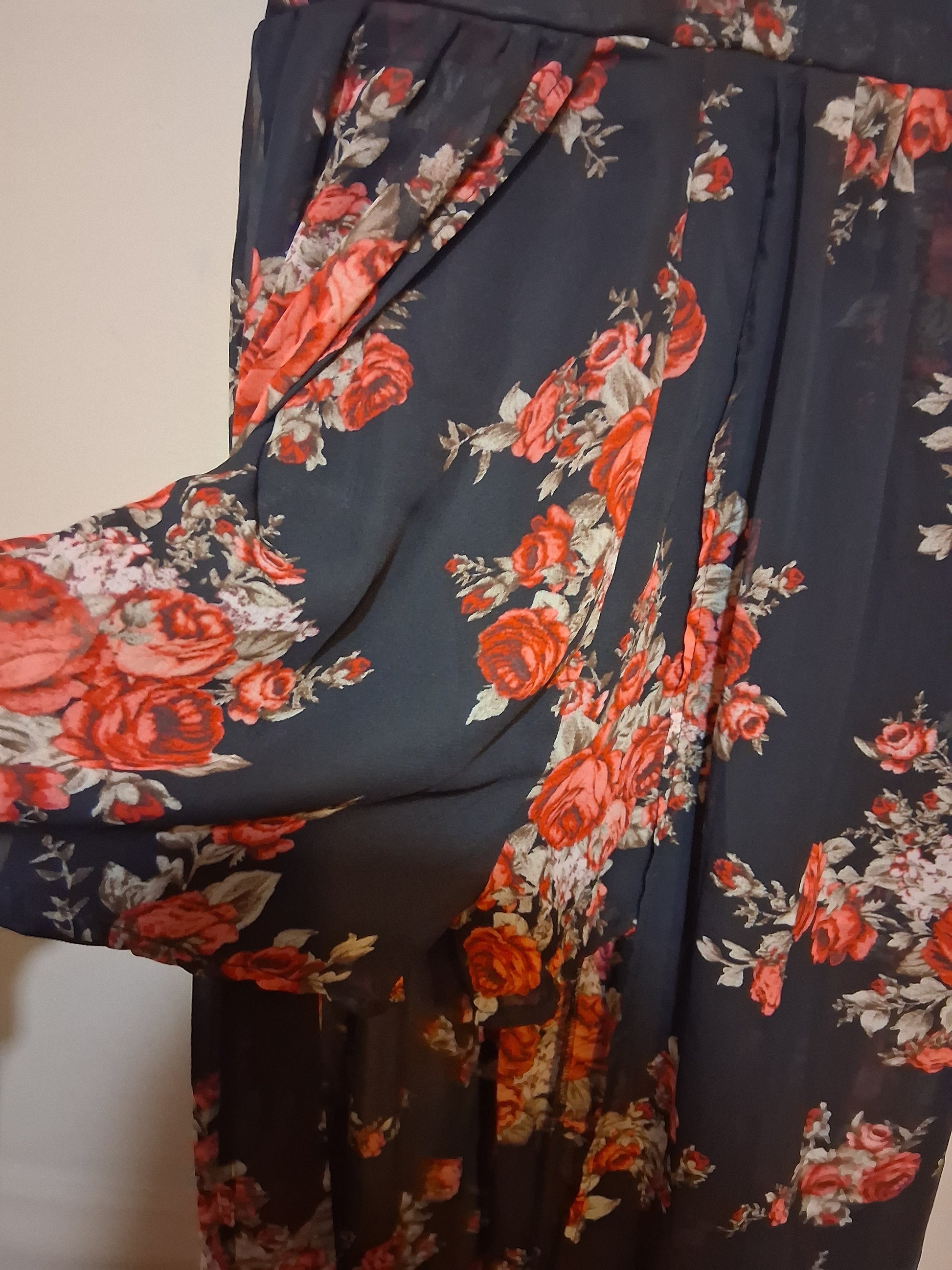 Floral Lace-Up Wide Leg Jumpsuit showing vibrant pink and red rose patterns on a black background.